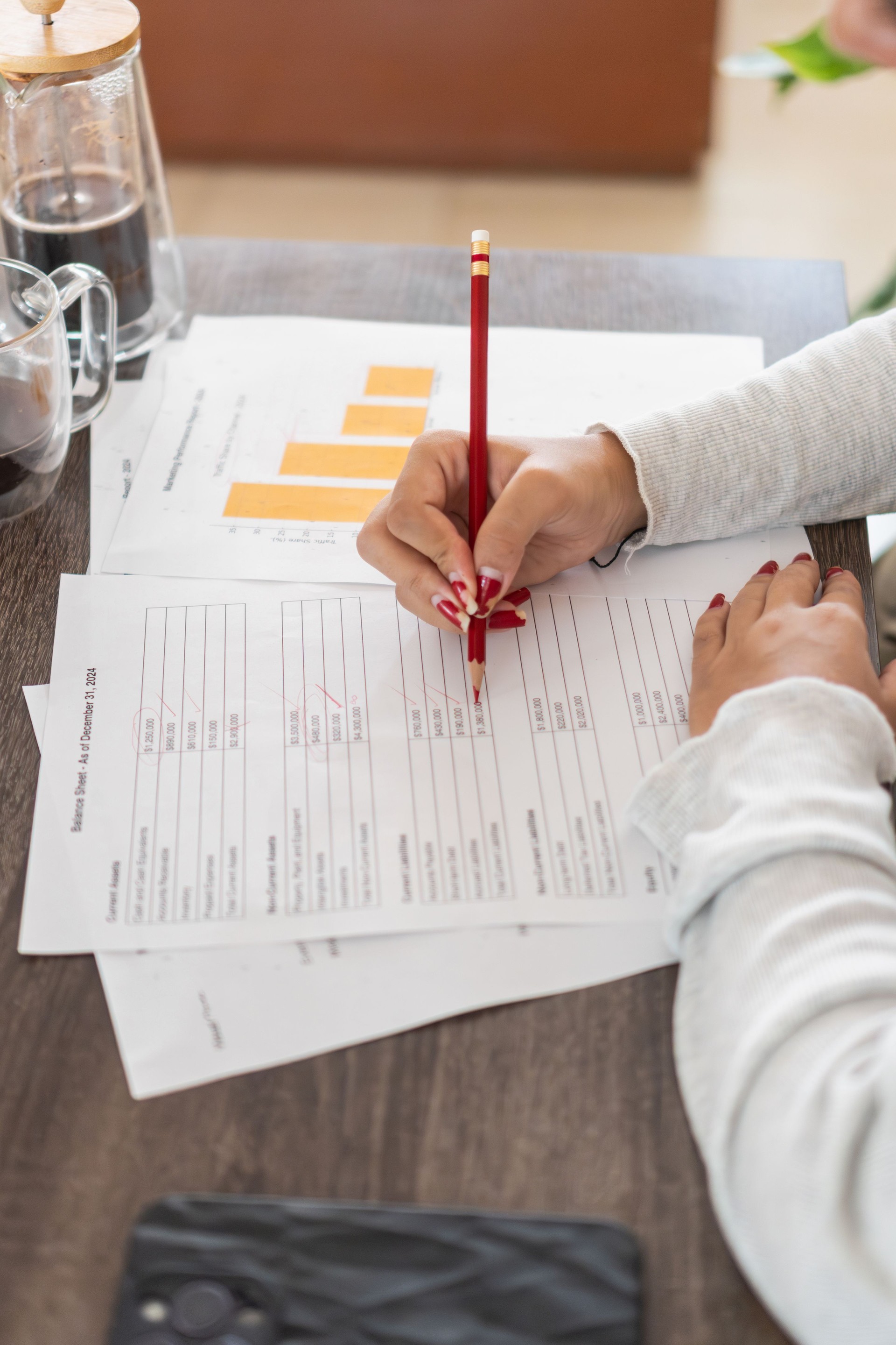 Businesswoman checking financial report and correcting mistakes at home office Businesswoman checking financial report and correcting mistakes at home office